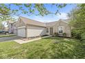Inviting single-Gathering home with a two-car garage, partial brick facade, and a neatly kept lawn at 7841 Whitaker Farms Ln, Indianapolis, IN 46237