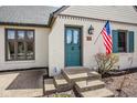 Close up of front door, steps, flower garden and part of front lawn at 7845 Allisonville Rd, Indianapolis, IN 46250