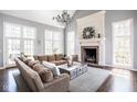 Spacious living room with a large sectional, fireplace, and plenty of natural light at 7845 Allisonville Rd, Indianapolis, IN 46250