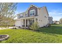 Beautiful view of a two-story home with well-maintained lawn and landscaping at 7901 Apalachee Dr, Indianapolis, IN 46217