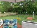 A serene backyard features a manicured lawn, lush trees, and a charming wooden bridge, creating a private outdoor oasis at 853 Westpointe Dr, Shelbyville, IN 46176