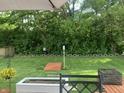 A serene backyard offers green space, a fire pit, and mature trees creating a private outdoor oasis at 853 Westpointe Dr, Shelbyville, IN 46176