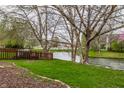 Picturesque backyard with mature trees, a serene pond view, and a charming wooden fence creating a private retreat at 8618 Turnstone Ct, Indianapolis, IN 46234