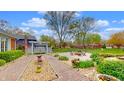 The backyard has a lovely pergola and a firepit area at 8842 Rocky Ridge Rd, Indianapolis, IN 46217
