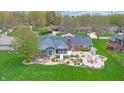 Aerial view of the backyard with a patio, landscaping, and mature trees at 8842 Rocky Ridge Rd, Indianapolis, IN 46217