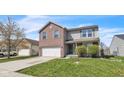 Charming two-story home featuring a brick and siding facade, attached two car garage, and a well manicured front lawn at 8888 N White Tail N Trl, McCordsville, IN 46055