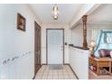 Inviting entryway with tile floors, wallpaper, and white front door at 990 Broadway N Dr, Plainfield, IN 46168