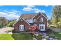 Beautiful brick home with manicured lawn and landscaped stone steps to front entrance at 10715 Hamilton Pass, Fishers, IN 46037