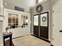 Inviting foyer with high ceilings, dark wood double door, and glass door to office at 10715 Hamilton Pass, Fishers, IN 46037