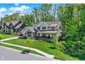 Picturesque two-story home with lush greenery, sidewalk access, and neighborhood charm at 10725 Holliday Farms Blvd, Zionsville, IN 46077