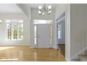 Inviting foyer featuring hardwood floors, white trim, and a view of the front door with sidelights at 10911 Innisbrooke Ln, Fishers, IN 46037