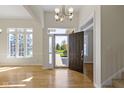 Bright foyer with hardwood floors, large windows providing natural light, and an open doorway at 10911 Innisbrooke Ln, Fishers, IN 46037