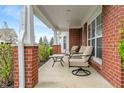 Relaxing front porch featuring comfortable seating and a view of the landscaped yard at 1352 Middlebury Dr, Westfield, IN 46074