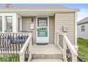 Inviting front porch with seating, a welcome door hanger, and well-maintained landscaping at 1412 Wallace Ave, Indianapolis, IN 46201