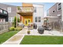 The backyard has a large patio, a grill, and a wooden deck for entertaining at 1453 English Ave, Indianapolis, IN 46201