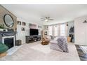 Cozy living room with a fireplace, comfortable seating, and plenty of natural light at 15986 Bugle Ridge Dr, Noblesville, IN 46060