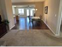 Dining area with hardwood floors and view of living room and back patio doors at 160 Bay Ridge Dr, Pendleton, IN 46064