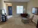 Cozy living room with neutral carpet, blue front door, and ample natural light at 160 Bay Ridge Dr, Pendleton, IN 46064