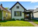 Charming two-story home with a well-maintained lawn and inviting front porch at 1917 Fletcher Ave, Indianapolis, IN 46203