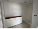 Bathroom with modern white cabinets, shower stall, and neutral color scheme at 196 Aster Way, Greenfield, IN 46140