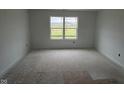 Bright bedroom featuring a large window with scenic views, awaiting your personal touch at 196 Aster Way, Greenfield, IN 46140