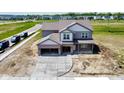 New two-story home featuring an attached garage and covered front porch in a suburban neighborhood at 196 Aster Way, Greenfield, IN 46140