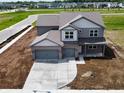 New two-story home featuring attached garage and front yard awaiting landscaping at 196 Aster Way, Greenfield, IN 46140