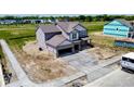 New two-story home featuring an attached garage and modern siding, surrounded by a newly constructed landscape at 196 Aster Way, Greenfield, IN 46140