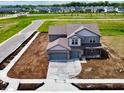 Newly constructed two-story home featuring attached garage in a developing community at 196 Aster Way, Greenfield, IN 46140
