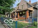 Classic two-story home featuring a cozy front porch, and green lawn at 2001 Hoyt Ave, Indianapolis, IN 46203