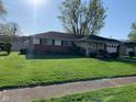 A charming ranch home with well-maintained lawn, landscaping, and an attached garage at 2141 N Cole St, Indianapolis, IN 46224