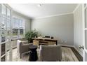 Cozy home office with a desk, two chairs, and large windows for natural light at 2168 Hengist Dr, Westfield, IN 46074