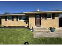 Charming brick home with a well-manicured lawn and flower beds at 263 Clark Ave, Beech Grove, IN 46107