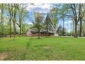Charming single-story house with a brick facade and vinyl siding, surrounded by mature trees and a well-kept lawn at 2920 N Buck Creek Rd, Greenfield, IN 46140