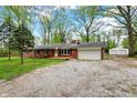 This inviting single-story brick home offers a well-maintained exterior with a detached garage and ample parking space at 2920 N Buck Creek Rd, Greenfield, IN 46140