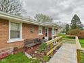 Close up of the front porch featuring a ramp, bench, and brick exterior at 306 W Clyde St, Frankton, IN 46044