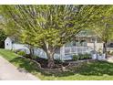 Beautiful house featuring light blue siding, a cozy front porch, and established landscaping at 316 S Arlington Ave, Indianapolis, IN 46219
