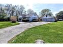 View of the exterior of a well-maintained house with a detached garage at 3514 Carson Ave, Indianapolis, IN 46227
