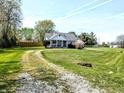 Inviting home on a sunny day, featuring a long driveway and lush green lawn at 3514 Carson Ave, Indianapolis, IN 46227