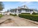 Exterior view of the home, featuring a long driveway leading to a detached garage and well-manicured hedges at 3737 Forest Ter, Anderson, IN 46013
