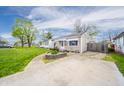 Quaint home with mature trees, a driveway, and a green lawn showcasing its curb appeal at 4203 Main St, Anderson, IN 46013