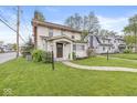 View of a well maintained home with a green lawn and sidewalk at 4575 N Guilford Ave, Indianapolis, IN 46205