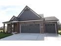 Beautiful home with a red brick exterior and a spacious two-car garage offering modern comfort at 5052 Carmine St, Brownsburg, IN 46112