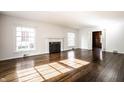 Bright, spacious living room with fireplace and hardwood floors at 5130 N Washington Blvd, Indianapolis, IN 46205
