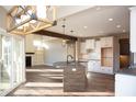 Open-concept kitchen featuring a center island, sleek countertops, and a view of the living area at 5179 Oak Ridge Trl, Columbus, IN 47201