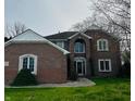 Charming brick home featuring classic architectural details and a well-maintained lawn at 5773 Station Hill Dr, Avon, IN 46123