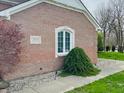 Close-up of brick home with manicured landscaping and charming architectural details at 5773 Station Hill Dr, Avon, IN 46123