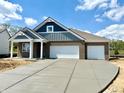 A modern home shows off its wide driveway and crisp, clean architectural lines at 5924 Trichel Dr, Greenwood, IN 46143