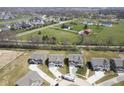 Aerial view of neighborhood with mature trees, sidewalks and green spaces, and attractive single-Gathering homes at 613 Waterford Ln, Westfield, IN 46074