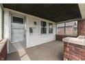 Inviting covered porch with brick accents, offering a cozy outdoor space at 620 S Irvington Ave, Indianapolis, IN 46219